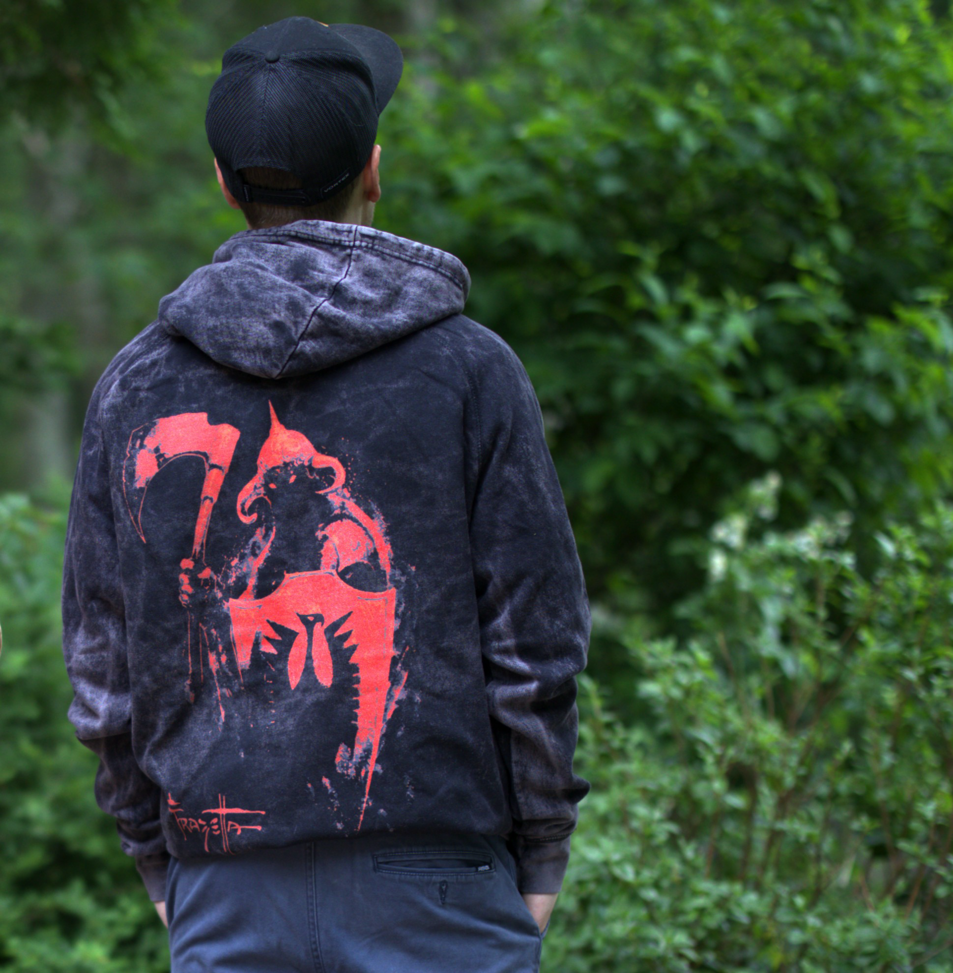 Photo of a man wearing the Death Dealer Crimson Hoodie – the back features Frazetta&