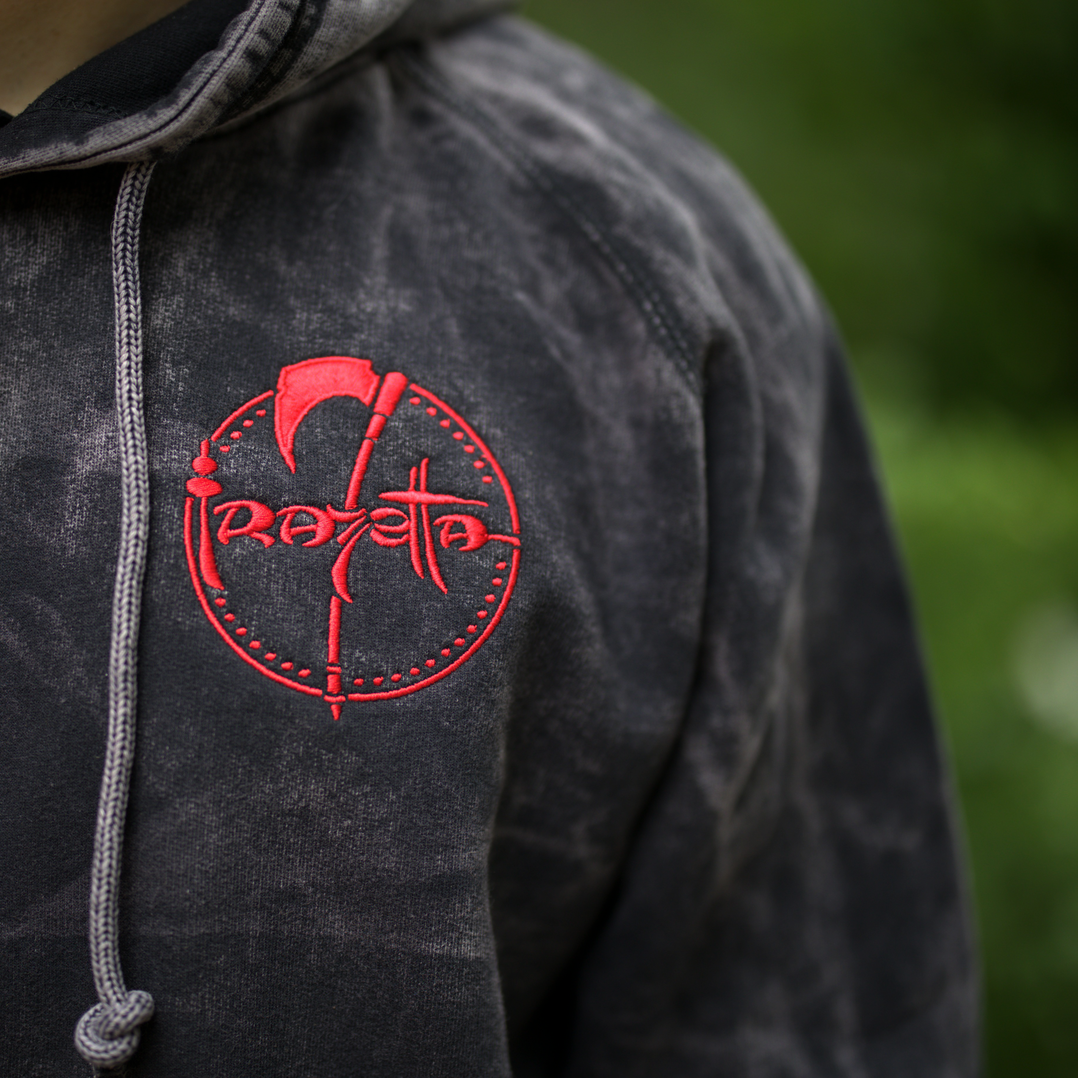 Photo of a man wearing the Death Dealer Crimson Hoodie – the front features the Frazetta Art Museum&
