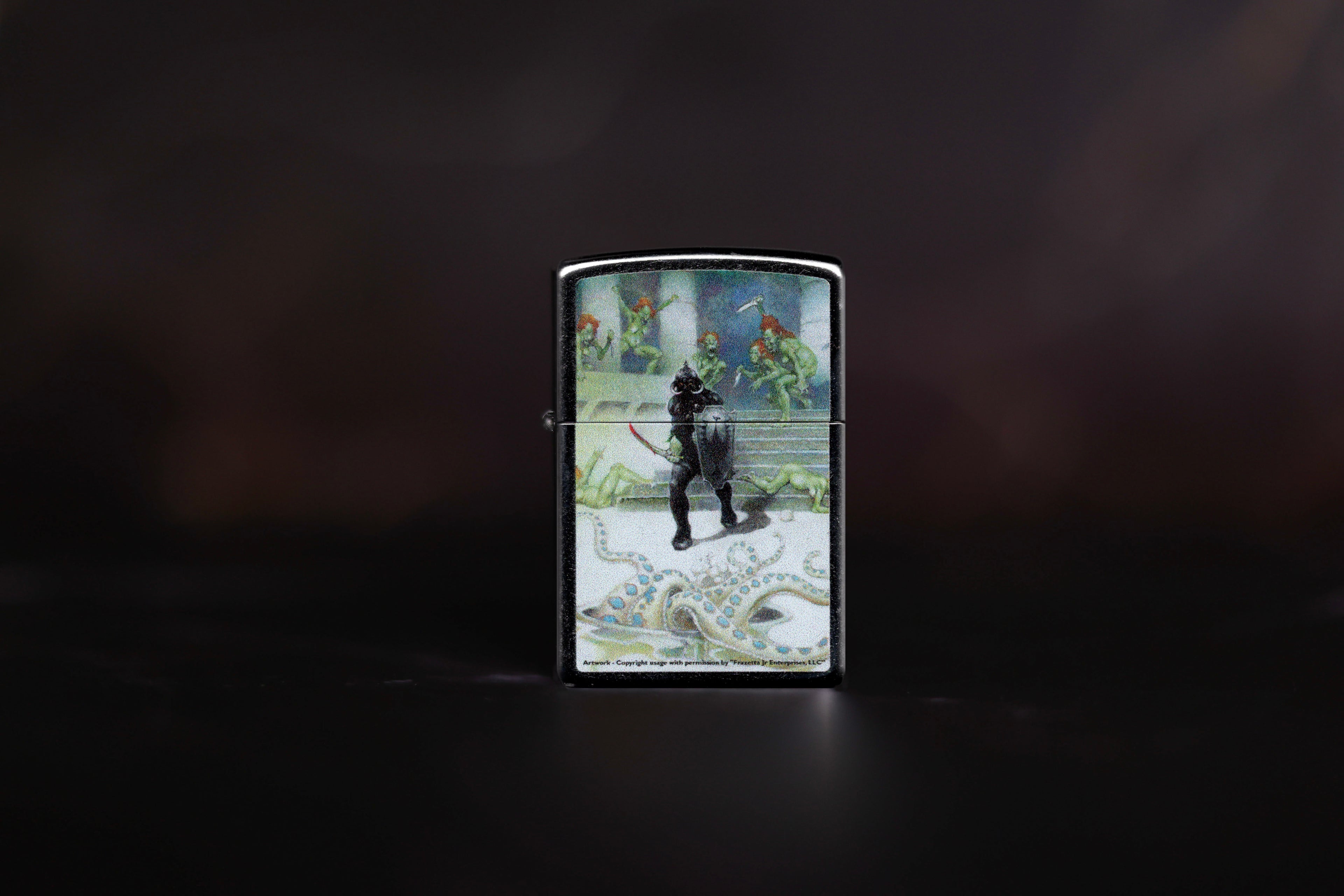 Zippo lighter showcasing "Death Dealer VII" by Frank Frazetta, an armored warrior stands on white stone steps, surrounded by green-skinned enemies and a giant tentacle.