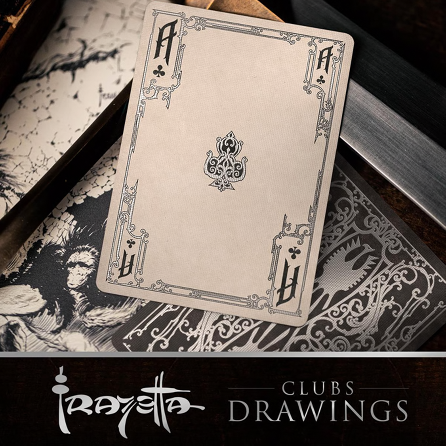A close-up of an Ace of Clubs from the Frazetta Drawings Edition playing card deck. The card features an ornate, vintage-style border with delicate filigree and a stylized club symbol at its center. Beneath it, additional cards are partially visible, showcasing intricate artwork and embossed detailing. A knife rests nearby, enhancing the dramatic composition.