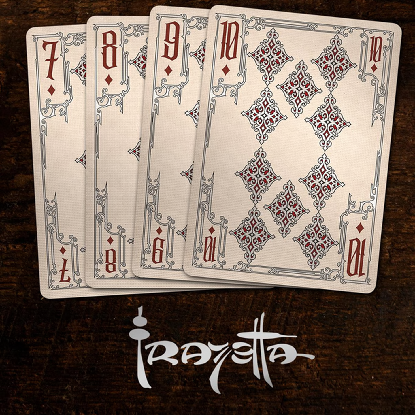 A close-up of cards seven through ten from the Frazetta Drawings Edition playing card deck. The cards feature an ornate, vintage-style border with delicate filigree and a stylized club symbol at its center. Beneath it, additional cards are partially visible, showcasing intricate artwork and embossed detailing.