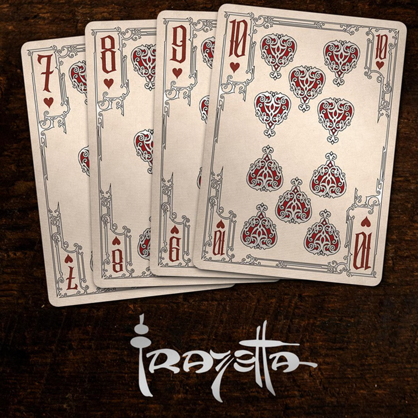 A close-up of cards seven through ten from the Frazetta Drawings Edition playing card deck. The cards feature an ornate, vintage-style border with delicate filigree and a stylized club symbol at its center.