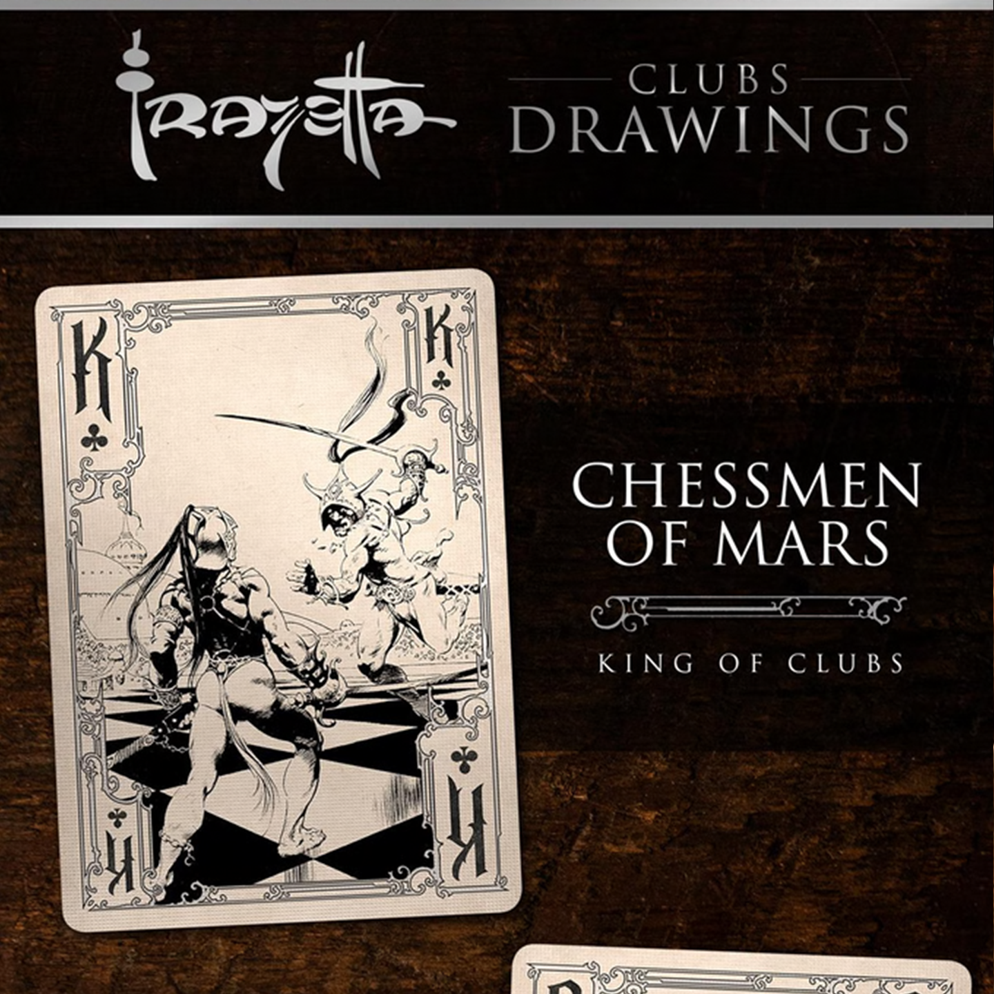 A close-up of a King of Clubs from the Frazetta Drawings Edition playing card deck. The card features an iconic Frazetta drawing with an ornate, vintage-style border with delicate filigree. Beneath it, additional cards are partially visible, showcasing intricate artwork and embossed detailing.