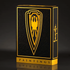 Frazetta Paintings Edition is displayed against a sleek, dark background. The black tuck box features intricate embossing, gold foil accents, and a bold shield emblem with a stylized eagle at its center. The side of the box is adorned with the Frazetta signature, enhancing its luxury and collector’s appeal. The reflective gold details catch the light, emphasizing the deck’s premium craftsmanship.