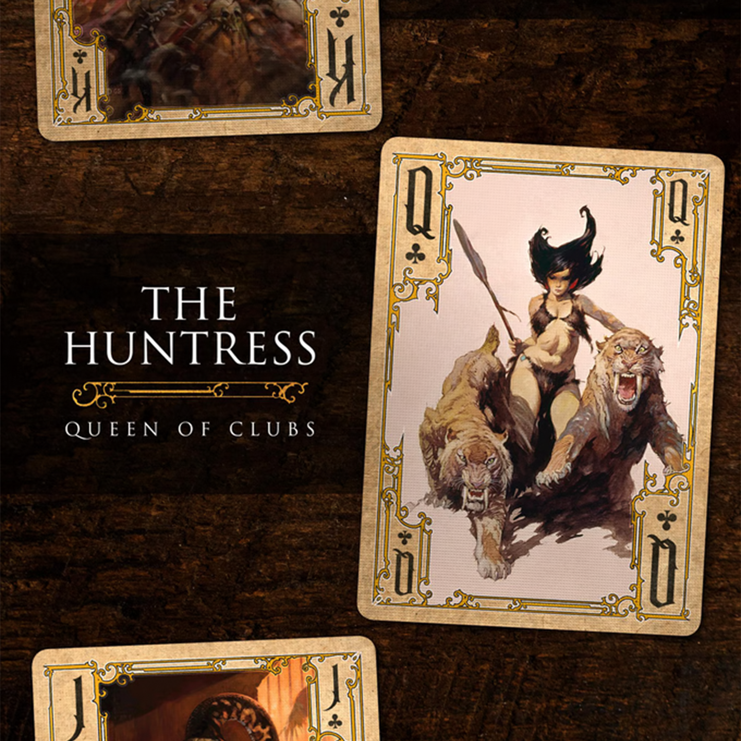 A close-up of a Queen of Clubs from the Frazetta Paintings Edition playing card deck. The card features an iconic Frazetta drawing with an ornate, vintage-style border with delicate filigree. Beneath it, additional cards are partially visible, showcasing intricate artwork and embossed detailing.