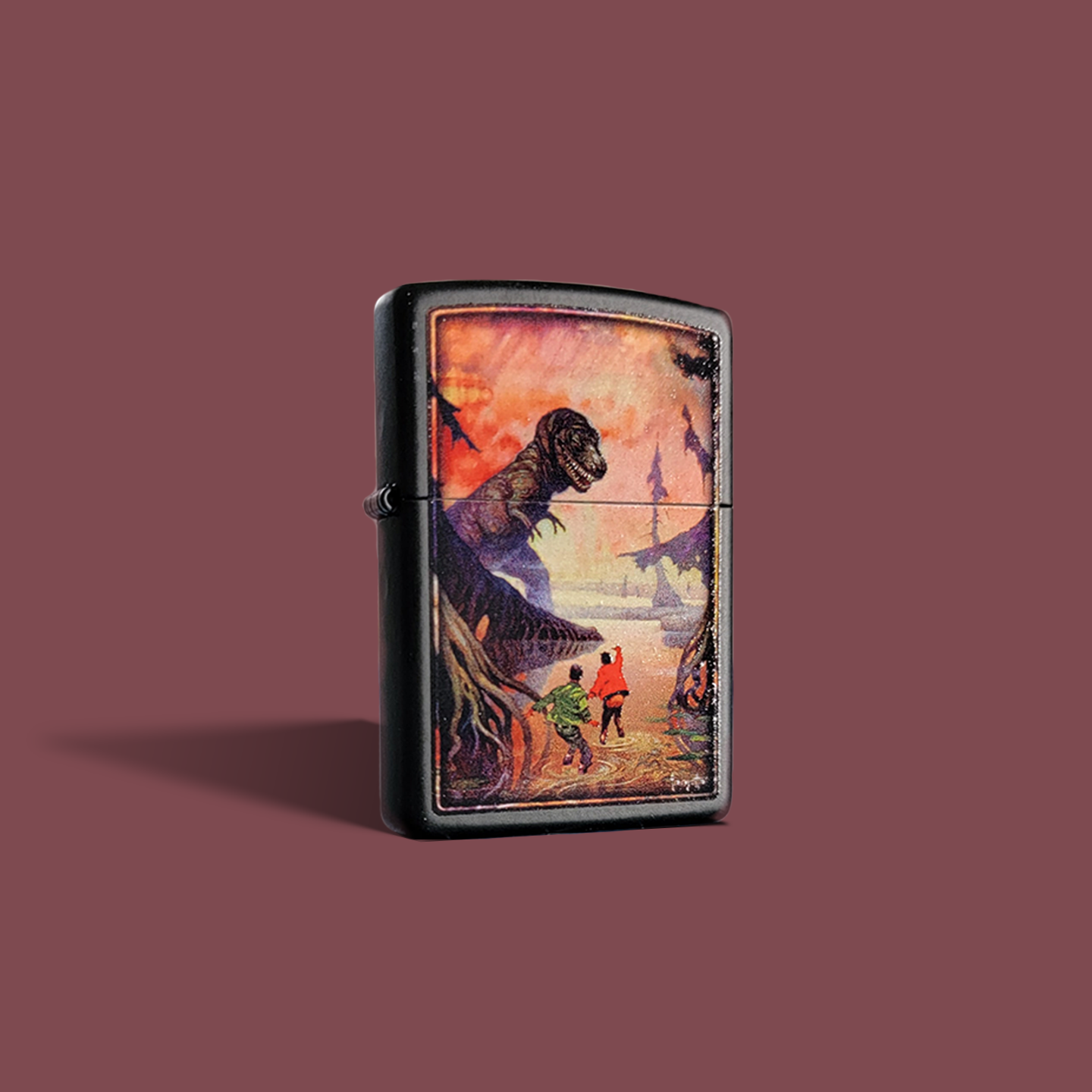 A Zippo lighter featuring Frank Frazetta’s “Swamp God” artwork, showing two figures fleeing through a dark, eerie swamp as a towering dinosaur-like beast looms above them. The vivid, sunset-toned sky adds contrast and drama to the scene.