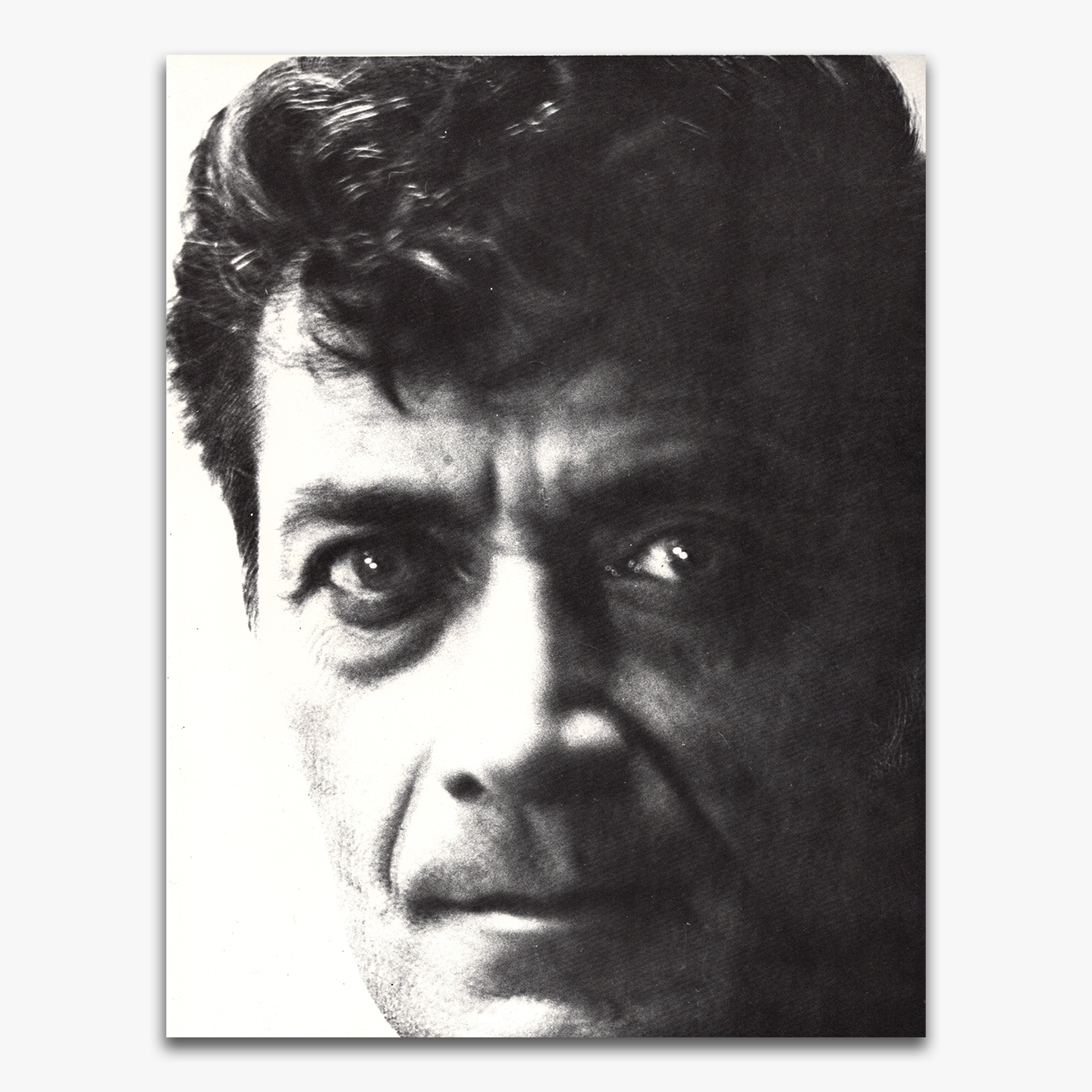Black and white close-up portrait of Frank Frazetta, showing his intense expression with a focus on his eyes and facial features.