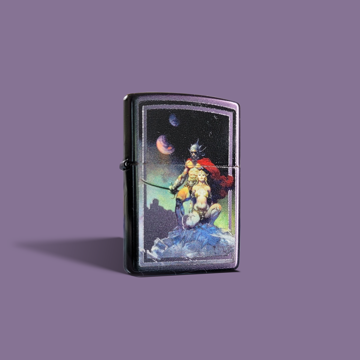 Zippo lighter featuring Frank Frazetta’s Swordsman of Mars, showcasing a powerful warrior and woman beneath a cosmic sky.