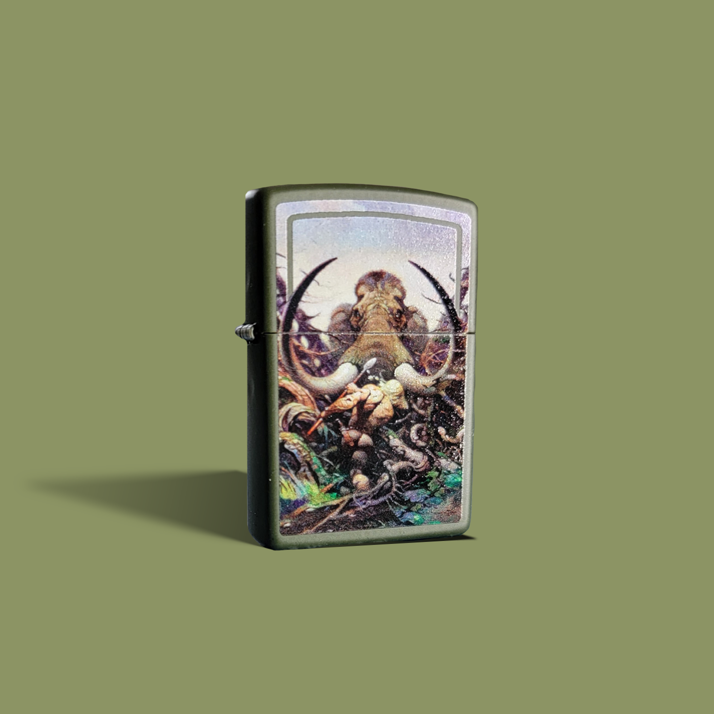 Premium Zippo lighter featuring Frank Frazetta’s legendary painting The Mammoth, depicting a muscular warrior locked in battle against a towering, tusked beast amid a chaotic wilderness.