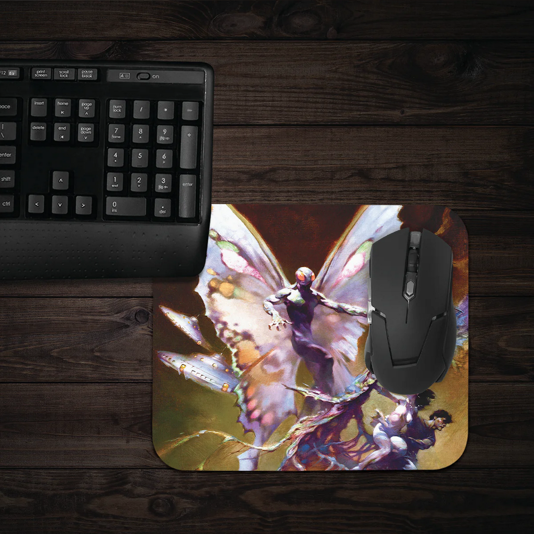 Mothman mousepad placed on a desk with a mystical fantasy setup