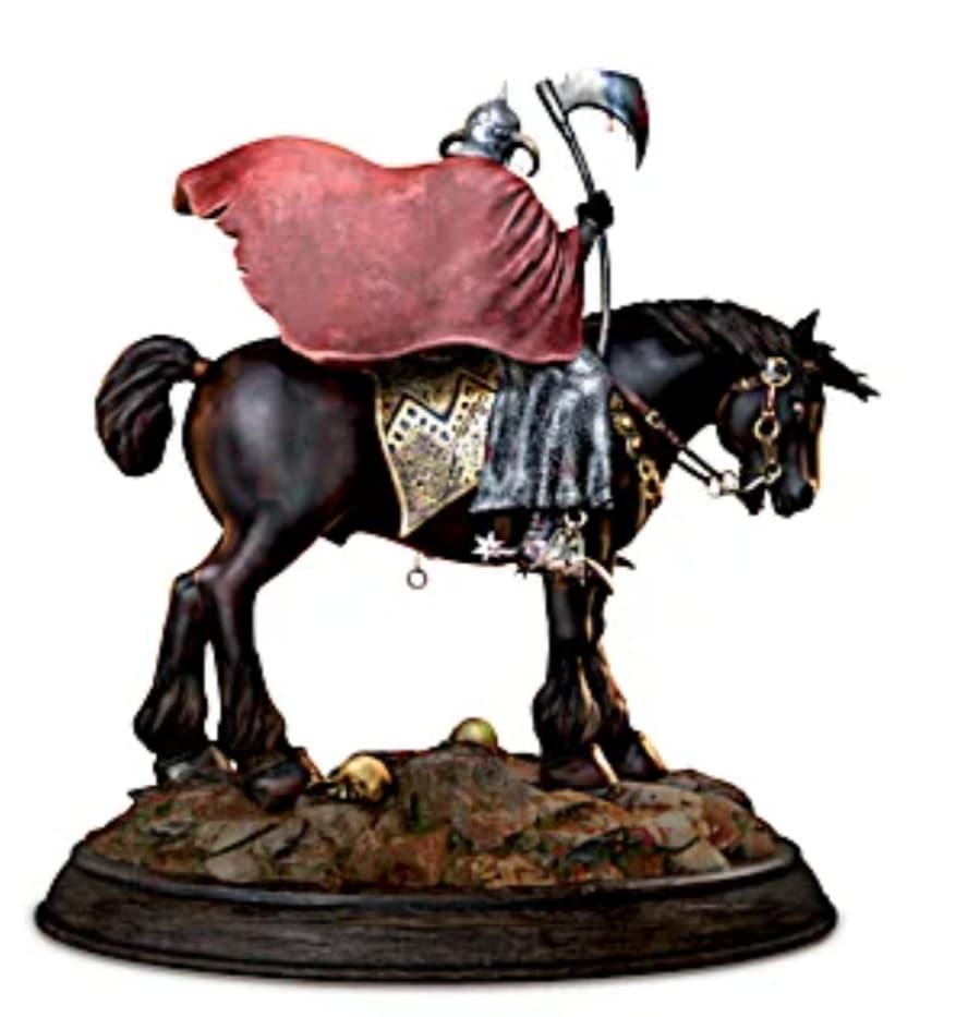 Rear view of the Death Dealer sculpture, depicting the armored warrior atop his black horse. His flowing red cape billows behind him as he grips a blood-stained axe. The base is detailed with rocky terrain and scattered skulls.