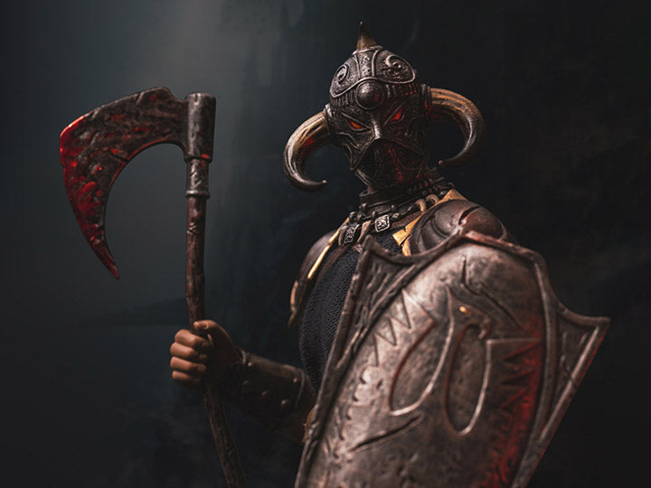 A 1/12 scale Death Dealer action figure stands in a dramatic pose, gripping a bloodstained battle axe and a weathered shield adorned with the Death Dealer emblem. The intricately sculpted horned helmet, glowing red eyes, and detailed armor capture the dark and menacing presence of Frank Frazetta’s iconic warrior. A moody, smoky background enhances the intimidating and battle-hardened aesthetic of this collectible figure.