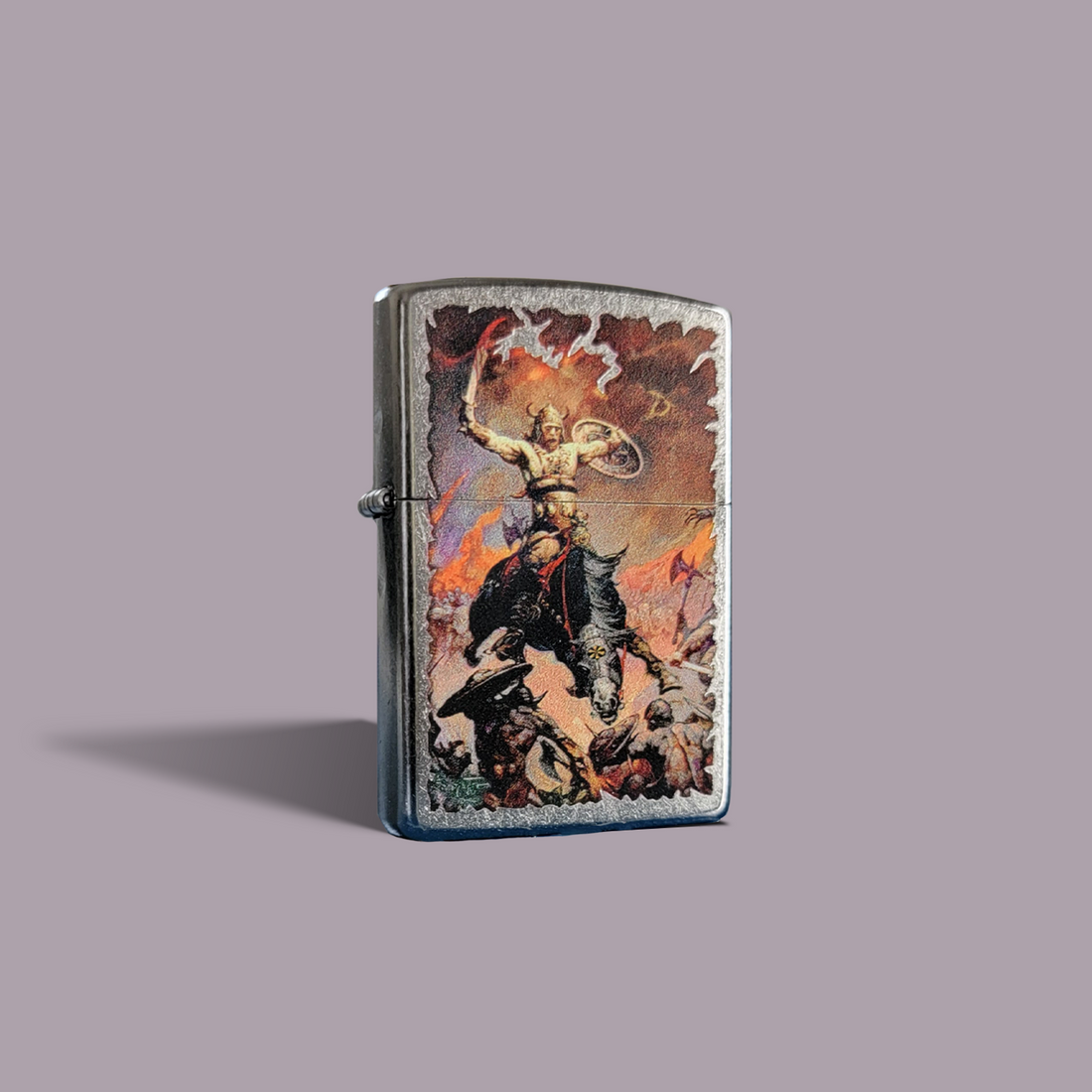 Zippo lighter featuring Frank Frazetta’s "The Berserker" artwork, depicting a battle-hardened warrior on horseback raising weapons to the sky amid fire and chaos.