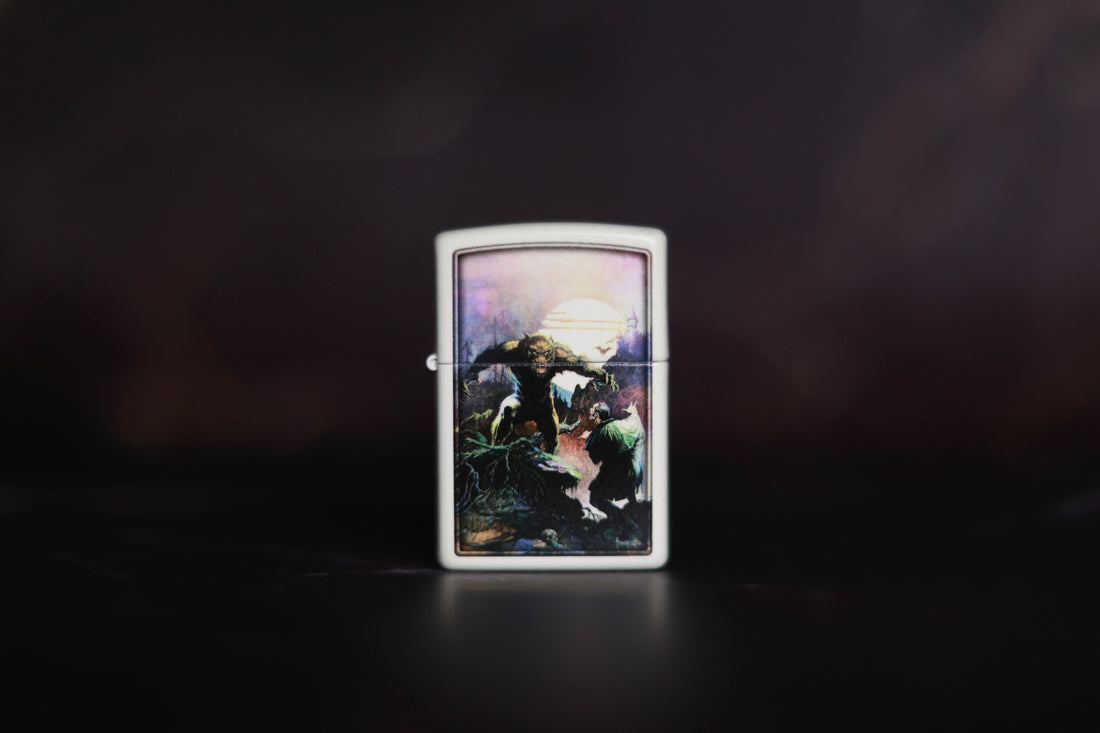 White Zippo-style lighter featuring Frank Frazetta’s artwork Wolfmoon, depicting a werewolf-like creature under a glowing full moon, confronting a cloaked figure amid a dark, moody landscape.